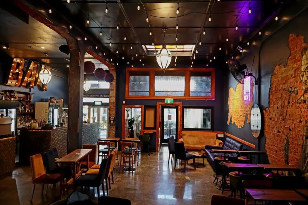 Common Room interior showing bar and tables looking out to front entrance