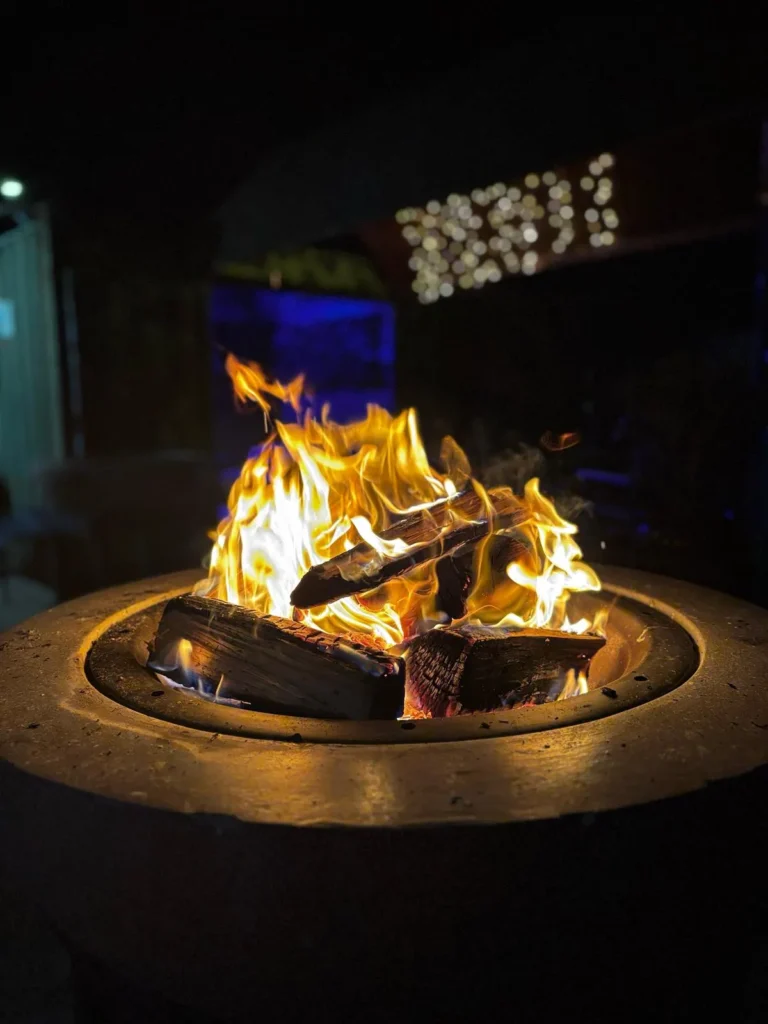 Common Room garden bar fire at night